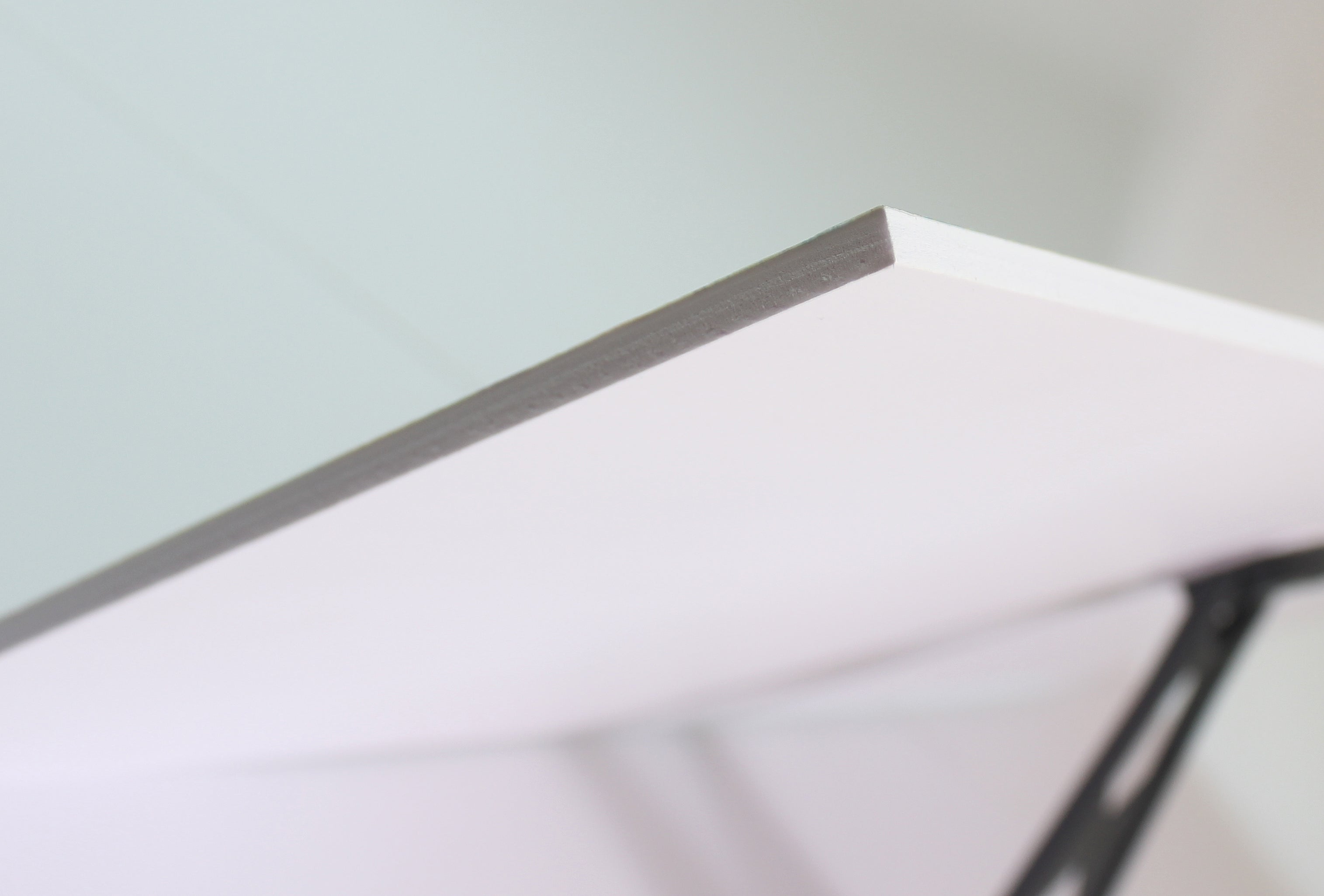 Close-up of a sleek laminate edge, showcasing smooth finish and craftsmanship.